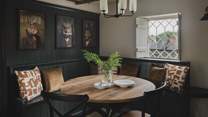 Dressed in rich hues of teal complemented by ochre cushions and characterful artwork...