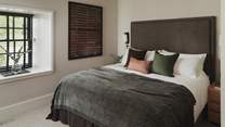 A super king size bed rests at the heart of the second bedroom
