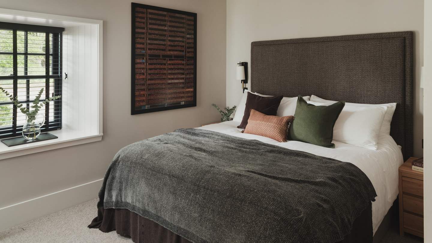A super king size bed rests at the heart of the second bedroom