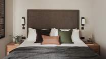 Adorned in calming hues, the second bedroom tempts for early nights and slow mornings