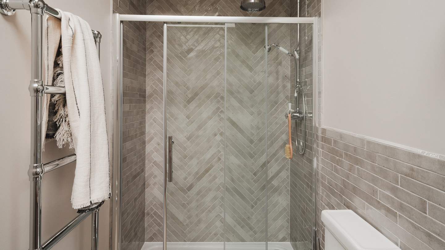 Relish soothing self-care rituals beneath the rainfall shower