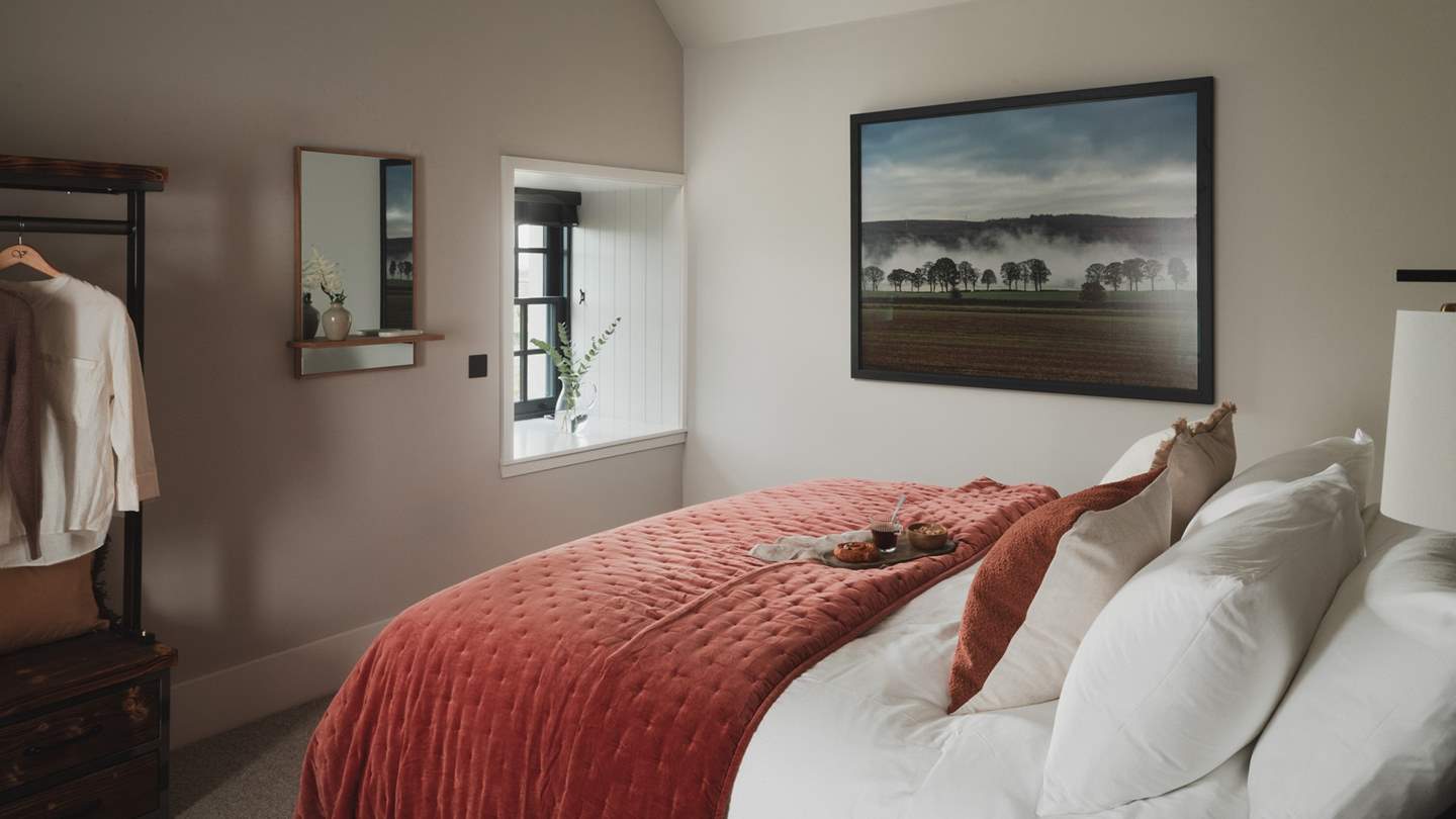 Beckoning for blissful repose, the first bedroom promises the sweetest sanctuary for rest 