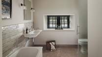 Home to both a bath and shower for rejuvenating selfcare