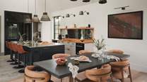 Step across the tiled floor and gather around the green marble-topped kitchen island