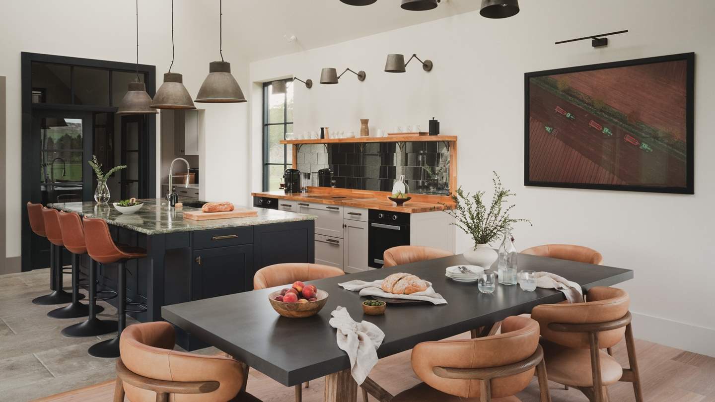 Step across the tiled floor and gather around the green marble-topped kitchen island