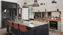 A mirrored backsplash reflects the exquisite views while you prepare flavoursome feasts