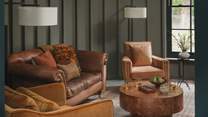 A sumptuous leather sofa is complemented by four leather armchairs for moments of unrivalled rest