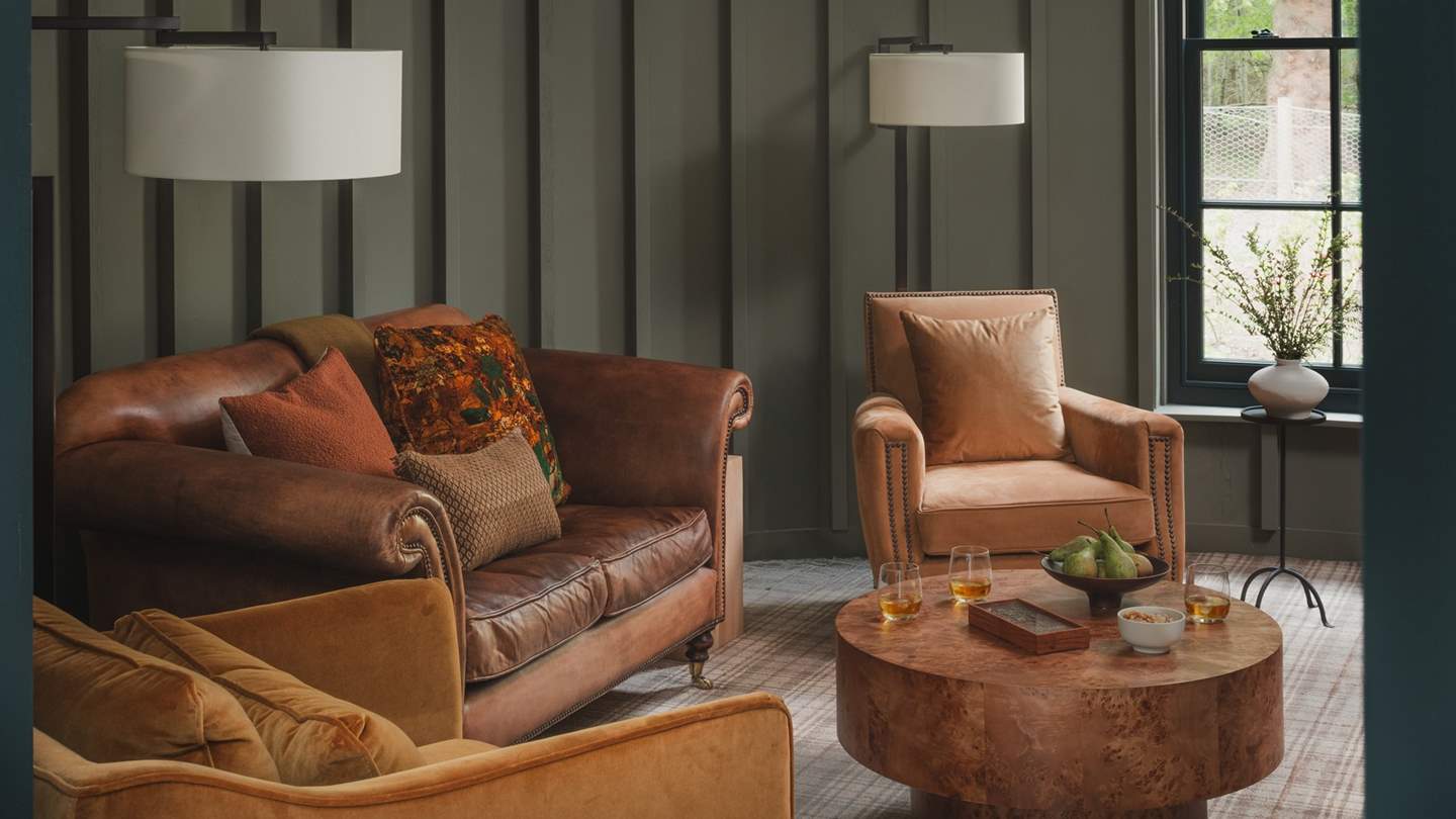 A sumptuous leather sofa is complemented by four leather armchairs for moments of unrivalled rest