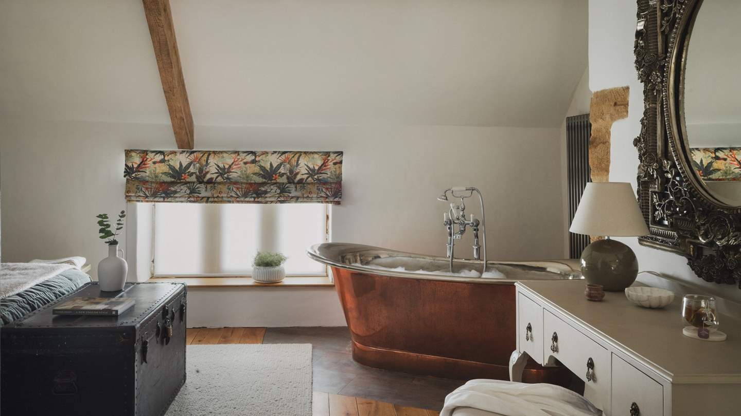 Beneath characterfully sloping ceilings and exposed beams awaits the copper rolltop bathtub
