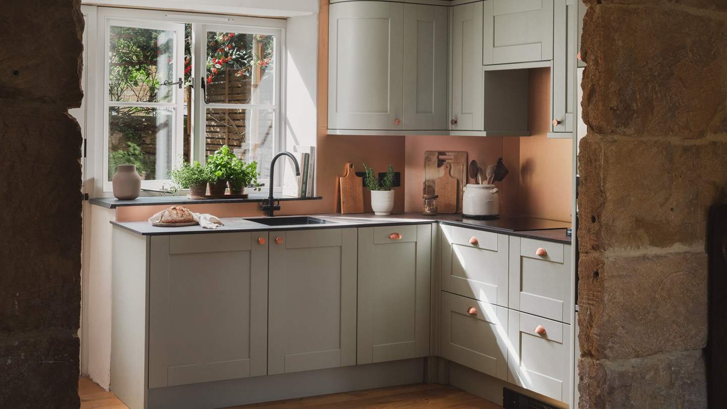 With bespoke cabinetry and adorned in sage and copper tones, this welcoming space hosts an array of accoutrements for epicurean delights