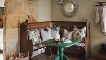 A cosy, vintage corner banquette resides in the adjoining dining area