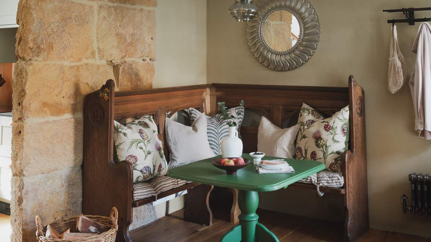 A cosy, vintage corner banquette resides in the adjoining dining area