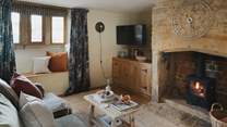 Heritage features and soothing tones lovingly entwine in this dreamy space, complete with a wood burning stove