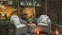 A serene space garlanded in greenery awaits for alfresco repasts
