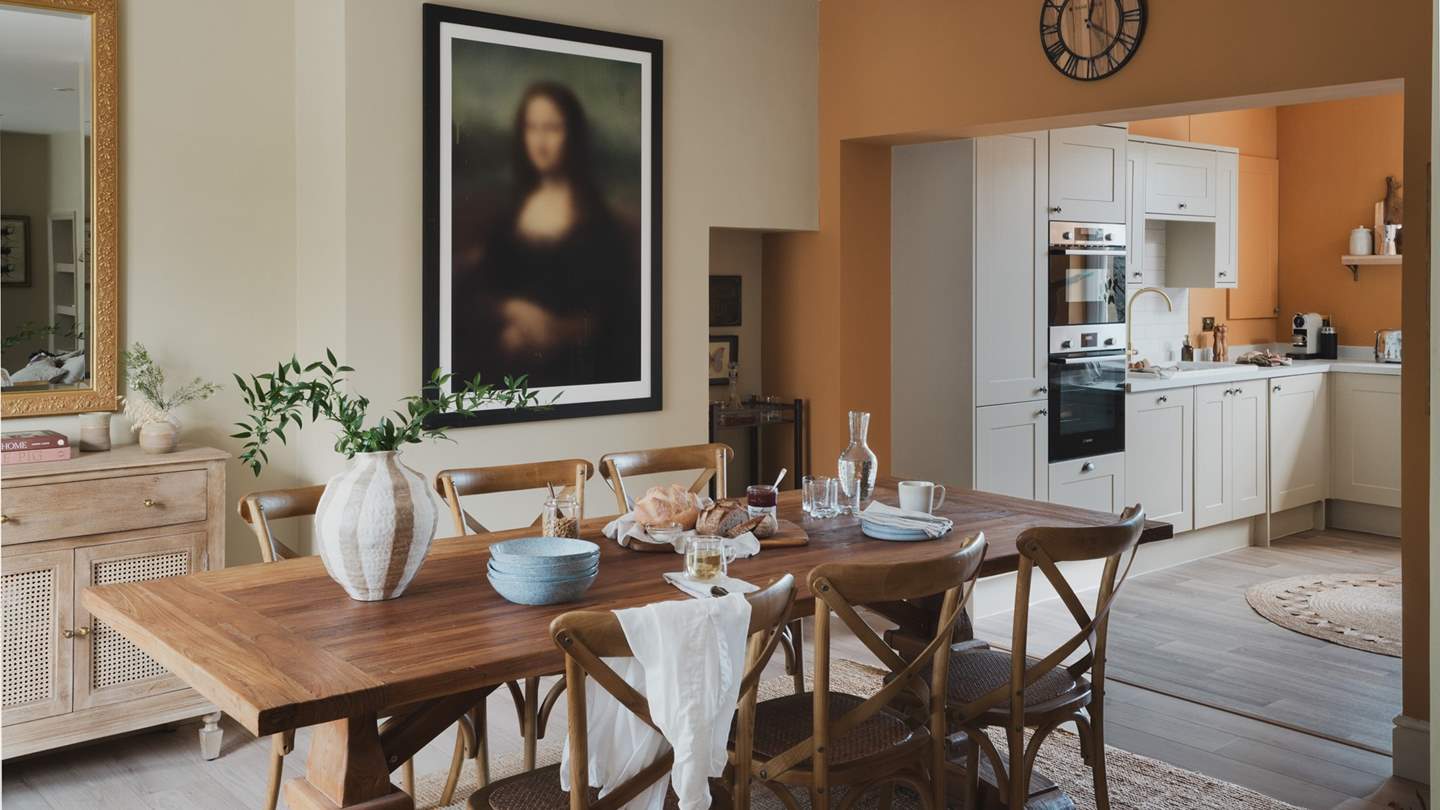 A teak Monastery table awaits with six oak bistro chairs