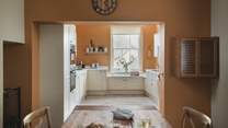 The kitchen is adorned in cinnamon hues 