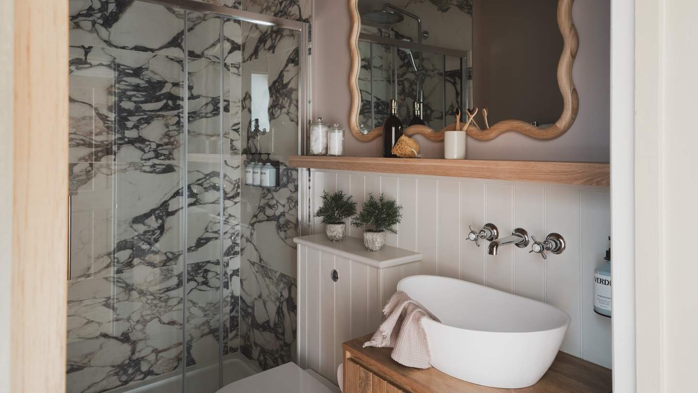 A walk-in rainfall shower promises refreshing self-care