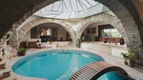Under a striking skylight, the 11m hourglass-shaped pool sits at the heart of Underhill