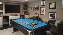 The games area beckons with a pool table, bar, and a 75” Smart TV with a full Sky package 