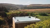 An urban cedar hot tub beckons for divine evenings immersed in a swirl of silky bubbles