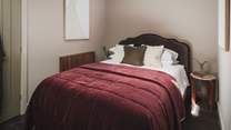 Adorned in a palette of earthy tones, the second bedroom welcomes blissful slumber