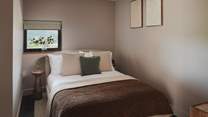 Bedroom four is layered in comforting blankets in chocolate hues 