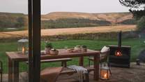 Settle in for cosy nights cocooned by the warming glow of the outdoor wood burner