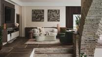 Two curved sofas invite you to relax within the main living room