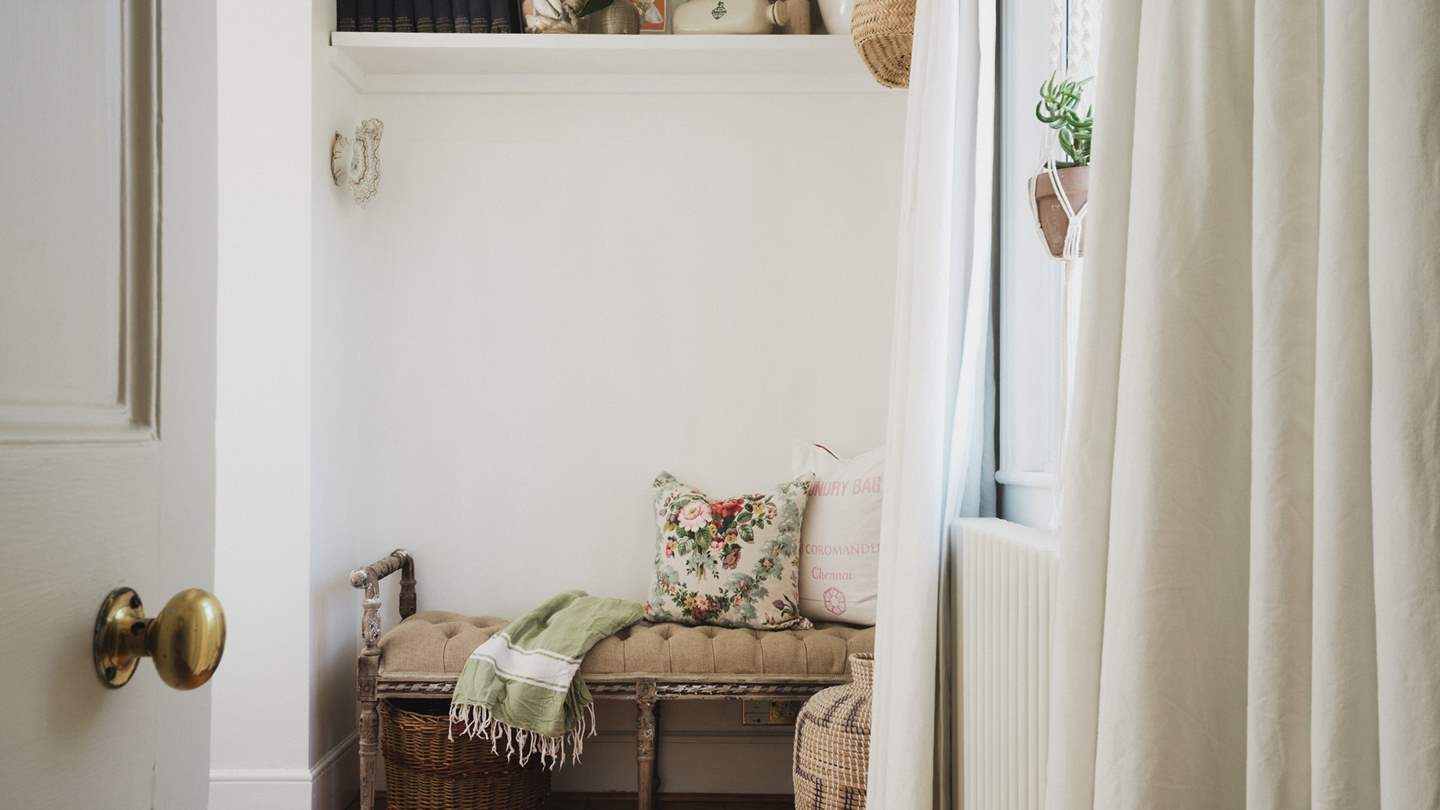 The space is complemented by a padded rustic bench and twin tallboy chests of drawers