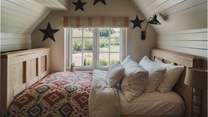 Offering further flexibility, a fourth bedroom resides across the hall, with a bespoke handmade single daybed 