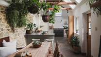An antique monk’s bench and four dining chairs comfortably seat up to seven