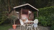 At the top of the garden, uncover the summer house