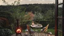 After dark, gather beside the warming glow of the firepit, listening to the soothing sounds of nature - please note that the chimenea has been replaced with a firepit 