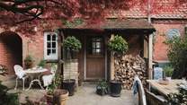 The characterful courtyard is filled with potted plants and trees 