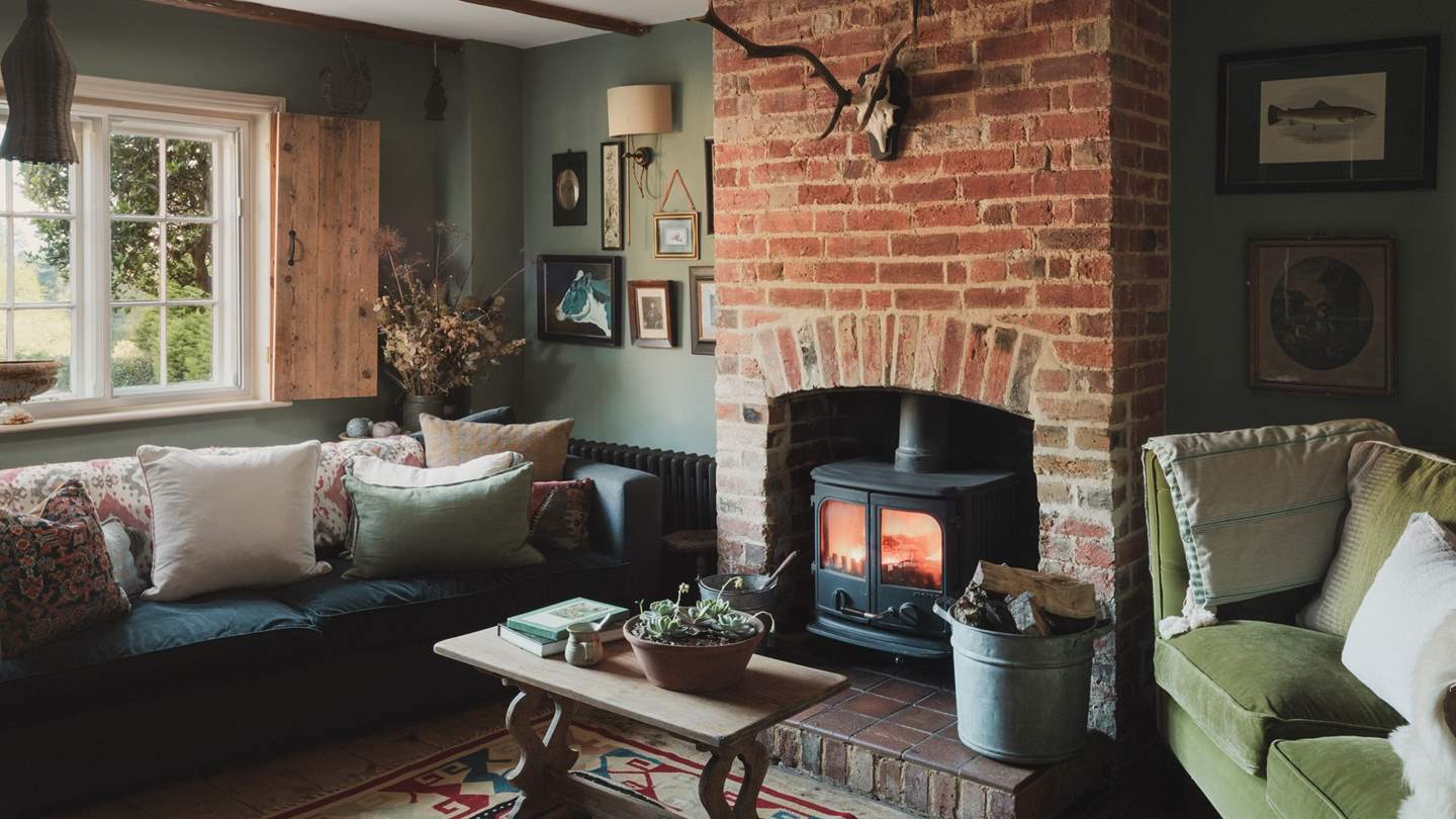 Handmade pitched pine shutters allow light to filter into this sultry, cocooning living area