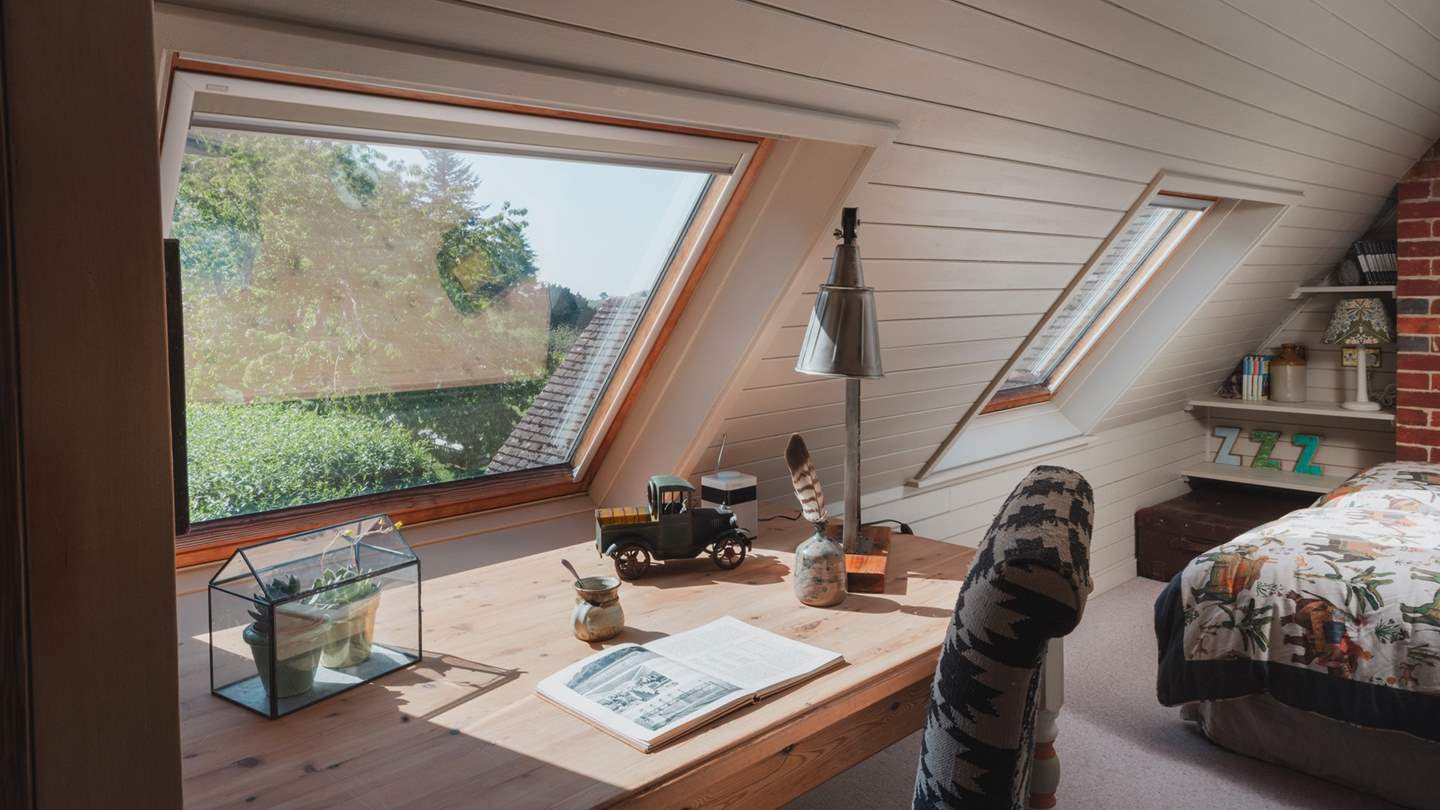 A built-in wardrobe, drawers and cupboards provide ample storage, alongside a rustic writing desk