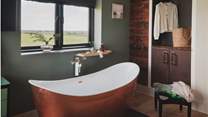 Relish deep soulful soaks in the large cooper bathtub
