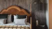 With a luxurious super king bed with the finest linens framed by a two-toned headboard