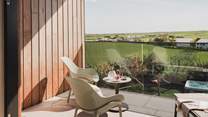 A relaxed seating area awaits on the balcony