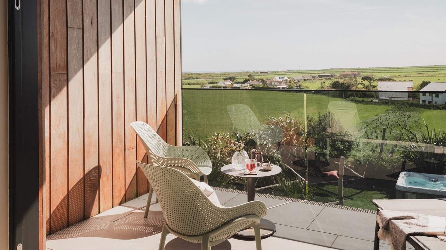 A relaxed seating area awaits on the balcony