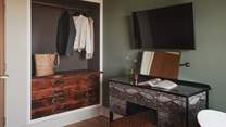 A bespoke open wardrobe and dressing table offer space to stow treasures