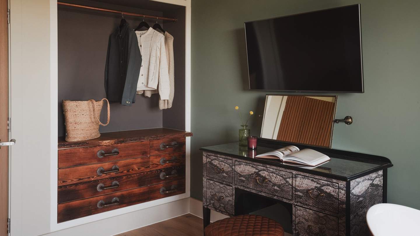 A bespoke open wardrobe and dressing table offer space to stow treasures