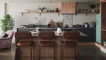 With speckled splashbacks for a touch of colour, the spacious kitchen is a culinary haven 