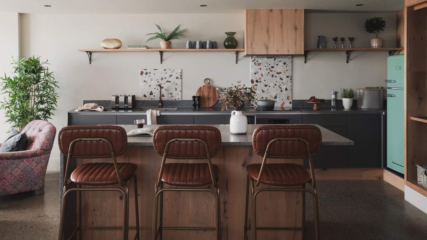 With speckled splashbacks for a touch of colour, the spacious kitchen is a culinary haven 