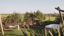 Rustic hammocks beckon for lingering moments as the sun dances across your skin 
