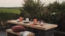 A long wooden table with benches evokes images of sun-warmed breakfasts overlooking verdant fields