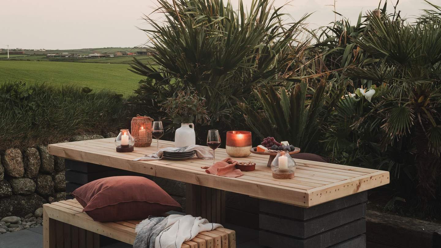 A long wooden table with benches evokes images of sun-warmed breakfasts overlooking verdant fields