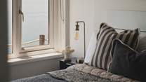 A restful sanctuary for repose, the first bedroom features a beautiful double bed