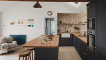 Flowing into the living area, the beautifully curated kitchen features an open-plan design framed by bay views