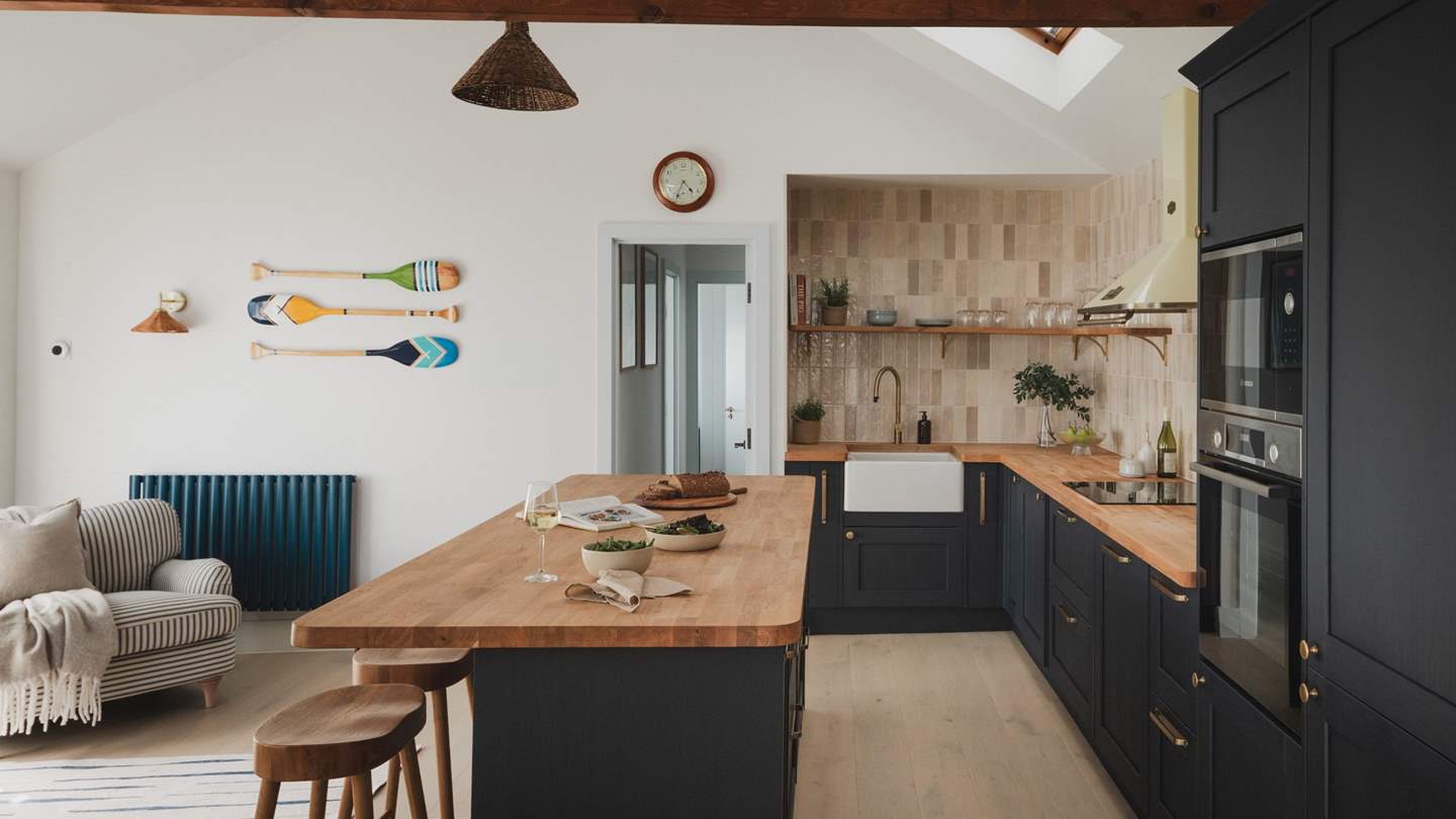 Flowing into the living area, the beautifully curated kitchen features an open-plan design framed by bay views